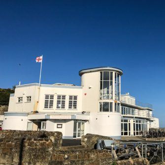 Art Deco grandeur of the white pained Winter Gardens buildings in Ventnor against a blue sky