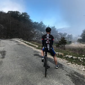 Cyclist at the summit of the Col de la Madone