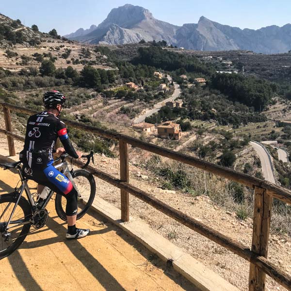 Cyclist admiring the view on the climb to Tarbena, Costa Blanca, Spain