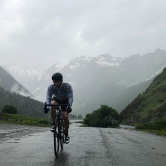 Cyclist in the rain cycling from Lac d'Estaing