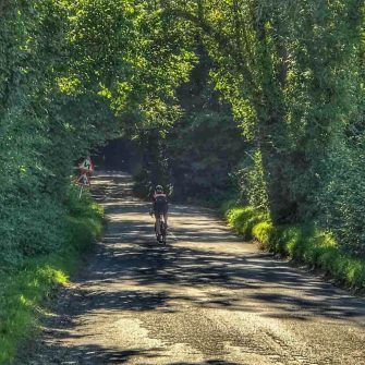 Cyclist climbing up Nyewood Hill on Velo South course