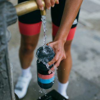 Cyclist filling water bottle in preparation for mallorca 312