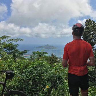 Cyclist looking at view over Seychelles