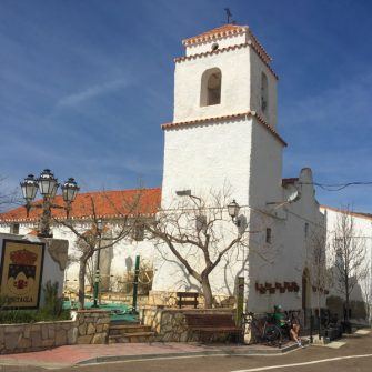 Church in Almeria village with cyclist outside