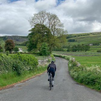 Cycling Malham Cove Yorkshire Dales copyright Epic Road Rides Cyclist on the road from Settle north towards Little Stainforth
