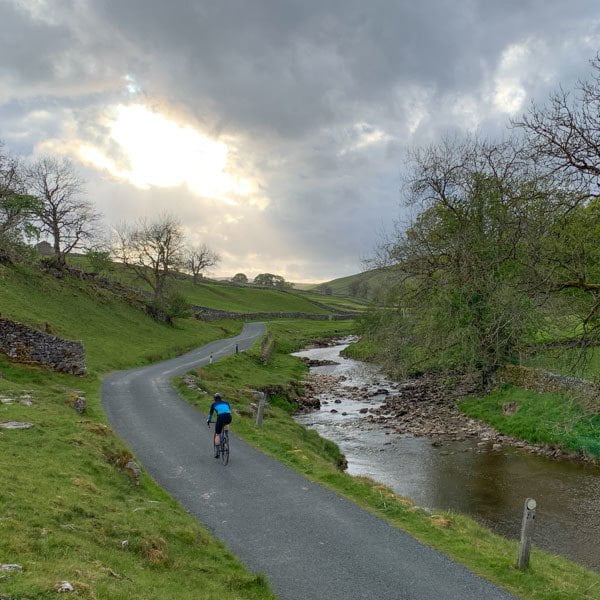 cycling alongside the rive wharfe, yorkshire dales