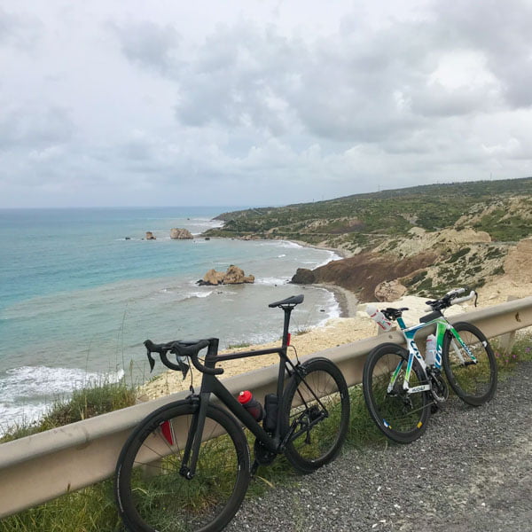 View to Aphrodite's rock with road bikes in foreground