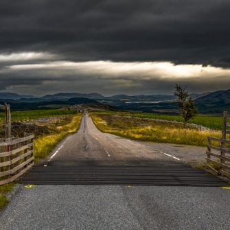 Looming clouds over a Scottish country road