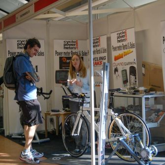 Discussing cycle power meters at a trade show