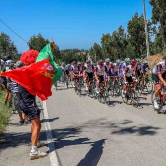 Cyclists are riding bicycles with the encouragement of the spectators on Volta ao Algarve